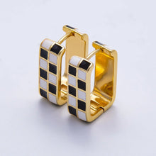 Load image into Gallery viewer, Black and white checkered enamel set on a square shaped huggies