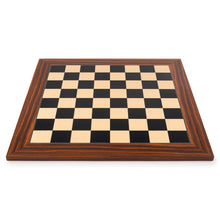 Load image into Gallery viewer, A straight-on, low-angle view of a square wooden chessboard with a rich rosewood border resting flat on a white surface.