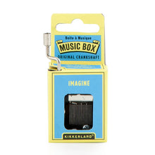 Load image into Gallery viewer, This image features the same small, hand-cranked music box package, this time designed with a light blue and pale yellow cardboard theme. A silver metal crank emerges from the upper left side, and the front blue panel displays the word "IMAGINE" right above the open window that shows the internal metal comb mechanism.