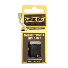 Load image into Gallery viewer, This image shows the same small, hand-cranked music box packaging, this time featured in a dark brown and pale yellow cardboard design. A silver metal crank extends up from the top left corner, and the front brown panel displays the text "TWINKLE TWINKLE LITTLE STAR" directly above the clear cutout window revealing the internal metal mechanism.