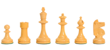Load image into Gallery viewer, Lineup of natural, light wood Staunton chess pieces—pawn, rook, king, queen, bishop, and knight—arranged side by side on green felt bases against a white background.