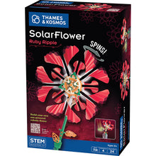 Load image into Gallery viewer, This image shows the packaging box for an engineering construction kit called "SolarFlower Ruby Ripple," designed for ages 8 and up by Thames & Kosmos. The box features a dark background dominated by a large, colorful graphic of a mechanical flower build with bright pink, ribbed plastic petals that spin around an intricate center made of white, green, and orange gears and a green stem.