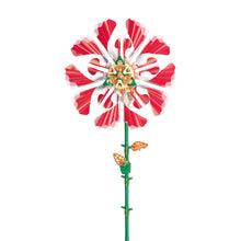 Load image into Gallery viewer, This image shows the completed construction of the "SolarFlower" device standing vertically against a stark white background. The robotic plant features a long, slender green stem with a few small orange leaf gears attached, leading up to a large symmetrical flower head built from overlapping layers of bright pink, fan-like plastic petals surrounding a central hub of interconnected orange and green mechanics.