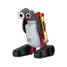 Load image into Gallery viewer, This image shows the completed "Pogo" jumping robot standing upright against a plain white background, balanced on two thick, dark grey tank treads. Its tall body consists of a white rectangular plastic core enclosed in a vibrant red frame, featuring long yellow rubber bands stretched down its sides and a grey head unit topped with two large, playful googly eyes.