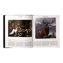 Load image into Gallery viewer, Open interior spread of an art history book displaying a classical still life painting of hunted game on the left page and a majestic oil painting of a stag deer standing against a mountainous landscape on the right page.