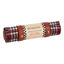 Load image into Gallery viewer, A rolled-up Pendleton plaid travel game mat secured with leather snap straps and wrapped in a cream product label.