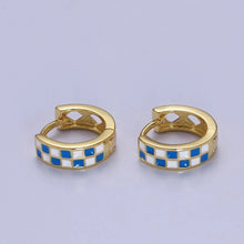 Load image into Gallery viewer, Small gold huggie hoop earrings featuring a smooth blue-and-white checkerboard pattern across the front. They snap securely closed with a hinged latch. The back inner curve of each thick metal band includes decorative diamond-shaped cutouts.