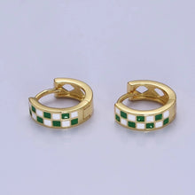 Load image into Gallery viewer, Small gold huggie hoop earrings featuring a smooth green-and-white checkerboard pattern across the front. They snap securely closed with a hinged latch. The back inner curve of each thick metal band includes decorative diamond-shaped cutouts.