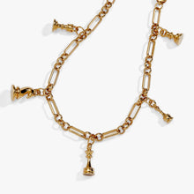 Load image into Gallery viewer, A close-up view of the gold link bracelet displaying dangling miniature chess piece charms, highlighting a central queen charm.