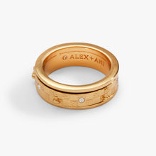 Load image into Gallery viewer, A gold spinner ring showing its smooth inner band engraved with the "Alex + Ani" logo, surrounded by a textured, chess-themed outer band with crystal accents.