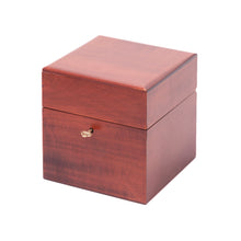 Load image into Gallery viewer, A closed, square wooden chest with a reddish mahogany finish and a small brass key inserted into the front keyhole against a white background.