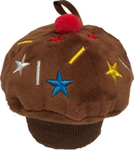 Load image into Gallery viewer, Set against a clean white background, a single plush chocolate cupcake baby toy. The toy features a dark brown ribbed base for the liner, a fluffy brown top decorated with colorful embroidered stars and sprinkles, and a small, fuzzy red pom-pom cherry stitched to the very top.