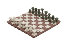 Load image into Gallery viewer, An elevated angle shot shows the flexible brown-and-cream chessboard fully set up with off-white and dark green mushroom chess pieces.