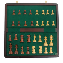 Load image into Gallery viewer, The opened interior of a folding chess set lined with green felt, containing individual slots holding light and dark wooden pieces.