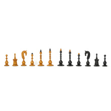 Load image into Gallery viewer, A full set of uniquely turned light and dark wooden chess pieces lined up side by side in a straight horizontal row against a white backdrop.