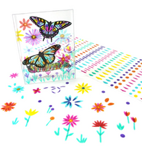 Load image into Gallery viewer, Standing upright on a clean white surface is a clear, transparent plastic box decorated with two large butterflies and a caterpillar, all filled in with vibrant, stained-glass-style colors. Placed next to the box is a long white sheet filled with rows of small, colorful translucent sticker dots, while several individual flower and stem stickers are scattered across the foreground.