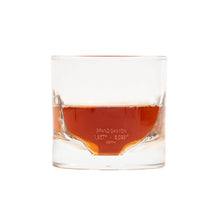 Load image into Gallery viewer, A rocks glass partially filled with amber whiskey, etched with "GRAND CANYON 1,857M 6,093 FT (DEPTH)" over a molded glass topography at the bottom.