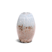 Load image into Gallery viewer, This oval-shaped glass vase features a translucent white body adorned with a shimmering gradient of speckled rose gold glitter clustered around the base and delicate vertical striations near the top.