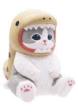 Load image into Gallery viewer, A small grey-and-white cat figurine sitting upright against a white background, dressed in a light tan eel costume. The cat's face sits inside the shark's open mouth, framed by jagged white teeth and a red inner lining, with dark spotted details lining the costume's back.