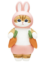 Load image into Gallery viewer, A standing ginger-and-white tabby cat figurine against a plain white background, wearing a pastel pink rabbit costume with long, upright bunny ears. The figure wears matching pink shorts and holds a bright orange carrot in each paw against its sides.