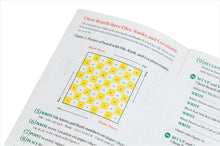 Load image into Gallery viewer, An open workbook page explaining chessboard notation, featuring a yellow-and-white grid diagram labeled with ranks and files alongside numbered exercises.