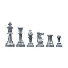 Load image into Gallery viewer, A line of metallic silver plastic chess pieces set against a white background, arranged in height order from king to pawn.