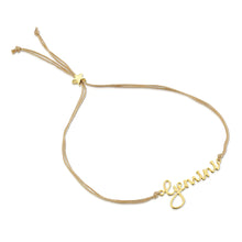 Load image into Gallery viewer, This image shows the unboxed "Gemini" bracelet arranged in a loose loop against a plain white background. The delicate cursive gold nameplate rests at the bottom, while the double-strand tan cord threads through a tiny, metallic gold star-shaped slider at the top to adjust the fit.