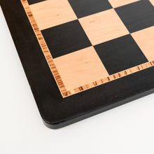 Load image into Gallery viewer, A close-up view of a chessboard corner highlighting the natural grain of the bird's-eye maple light squares and the detailed geometric mosaic inlay border.