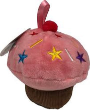 Load image into Gallery viewer, Set against a solid white background, a single plush pink cupcake baby toy. The toy features a dark brown ribbed base for the liner, a fluffy pink top decorated with multi-colored embroidered stars and sprinkles, and a small, fuzzy red pom-pom cherry stitched directly beneath a soft pink satin loop ribbon.