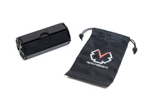 Load image into Gallery viewer, A fully folded black VentureBoard mini travel set shown alongside its matching black drawstring storage pouch emblazoned with the white-and-orange VentureBoard logo.
