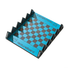Load image into Gallery viewer, An angled overhead view of an empty, unfolded VentureBoard mini travel chess board showcasing its bright blue-and-grey grid and grey plastic folding frame.