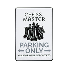 Load image into Gallery viewer, A white metal parking sign with a thin black border, displaying black and dark gray text along with a group of black chess piece silhouettes in the center. The top reads "CHESS MASTER", followed by "PARKING ONLY", and a humorous warning at the bottom that reads "VIOLATORS WILL GET CHECKED."