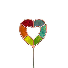 Load image into Gallery viewer, A single decorative, open heart-shaped plant stake.  Framed in a copper-toned border, the open heart features an empty center surrounded by a ring of six translucent, stained-glass panels in shades of red, orange, yellow, and green.
