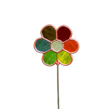 Load image into Gallery viewer, A single flower-shaped plant stake standing. Crafted in a stained-glass style with a copper-toned border, circular clear center surrounded by  translucent petals of red, orange, yellow, green, and blue.
