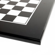 Load image into Gallery viewer, A close-up detail shot showing the glossy black border, white accent line, and high-contrast black and white squares of the chessboard corner.
