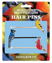 Load image into Gallery viewer, Set of three bobby pins featuring enamel songbirds: an American Goldfinch, Blue Jay, and Northern Cardinal.
