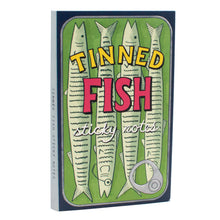 Load image into Gallery viewer, The front cover features a sardine can illustration with the text "TINNED FISH sticky notes" superimposed over four stylized fish against a green background.
