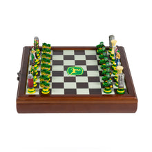 Load image into Gallery viewer, A straight-on, overhead perspective of a full farm-themed chess set arranged on a wooden board featuring a central John Deere logo.
