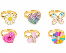 Load image into Gallery viewer, Set against a crisp white background, six adjustable gold-colored novelty rings are arranged in two rows of three. The diverse collection includes a white daisy with a yellow center, a heart encrusted with multi-colored crystals, a faceted gemstone butterfly, a layered hot-pink heart, a smooth pastel-pink butterfly, and a bright rainbow-petaled flower with a rhinestone center.
