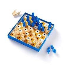 Load image into Gallery viewer, A peg-style chess game set up inside a blue box with blue and cream wooden pieces inserted into holes on a yellow-and-white checkered board.
