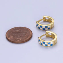 Load image into Gallery viewer, These small, blue-and-white checkered gold-toned huggie hoop earrings are a little smaller then a US penny. 
