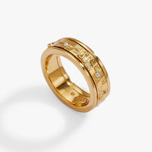 Load image into Gallery viewer, A gold spinner ring featuring a textured checkered pattern with raised chess motifs and embedded small round crystal accents.
