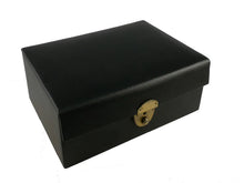 Load image into Gallery viewer, A closed black leatherette chess storage box featuring a polished brass lock clasp on the front.
