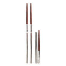 Load image into Gallery viewer, This image showcases a breakdown of the portable chopsticks against a plain white background, highlighting how they collapse. On the left stands a fully assembled pair with long, silver metal handles seamlessly transition into pointed brown wooden tips, while to the right, a single chopstick is shown completely unscrewed into its separate metal sleeve and wooden tip components.
