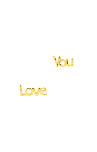 image of mismatching mini stud earrings spelling out 