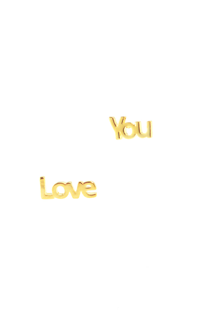 image of mismatching mini stud earrings spelling out 