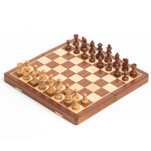 Load image into Gallery viewer, A complete wooden chess set is fully set up for play on an open folding wooden board.

