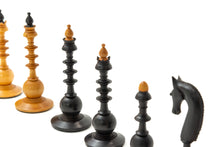 Load image into Gallery viewer, A close-up view of intricately turned, tall vintage wooden chess pieces displaying multi-tiered, spindle-like details with contrasting light and dark finials set against a white background.
