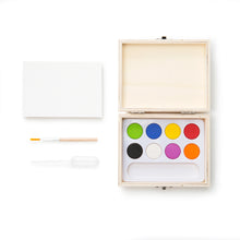 Load image into Gallery viewer, on-the-go mini watercolor paint set comes in a portable box with a brush, 8 paint color palette, pipette and 4.10” x 2.9” (A7) water color paper pad.

