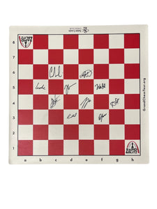 Image of red and whit vinyl board autographed by the players in the 2025 Rapid & Blitz Tournament 
